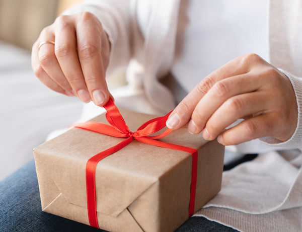 Hands unwrapping unpacking a present